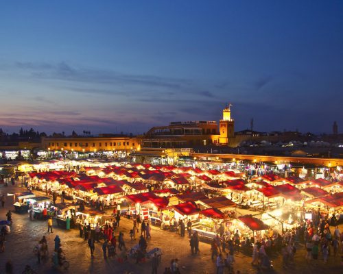 שוק רחוב עמוס בדוכנים בלילה.צילום מזווית עליונה. מרוקו